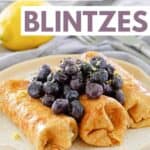 Three cheese blintzes on a plate.