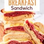 Corned beef breakfast sandwich halves on a wood board.