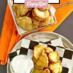 Homemade Hooters fried pickles in a wire basket and on a plate.