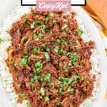 Instant pot pulled pork on top of rice on a platter.