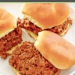 A few cheesy loose meat sandwiches on a plate.