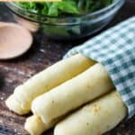 Homemade Olive Garden breadsticks wrapped in a cloth napkin.
