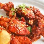 Homemade spicy Asian chicken wings on a plate.