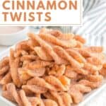 Homemade Taco Bell cinnamon twists piled on a small square plate.