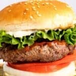 Homemade Burger King Whopper sandwich on a wood board.