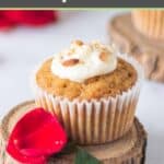 Homemade carrot cake cupcake on a small wood board.