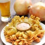 Copycat Chili's awesome blossom, large sweet onions, and a glass of beer.