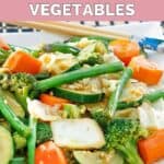 Homemade Panda Express mixed vegetables and chopsticks on a plate.