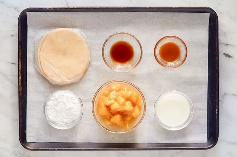 Copycat Taco Bell caramel apple empanada ingredients on a tray.