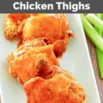 Homemade Wingstop Buffalo chicken thighs on a platter and celery sticks beside it.