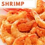 Homemade beer battered fried shrimp on a plate.