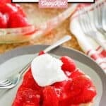Homemade big boy strawberry pie with a dollop of whipped cream on top.