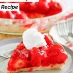 A slice of homemade big boy strawberry pie on a small plate and the pie behind it.
