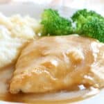 Homemade chicken gravy over chicken and mashed potatoes.