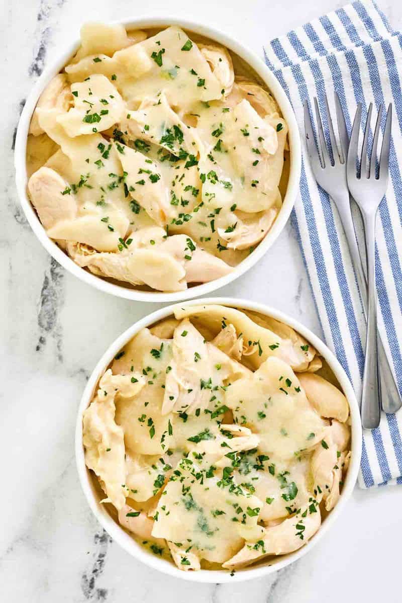 Copycat Cracker Barrel chicken and dumplings in two bowls and two forks beside them.