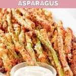 Homemade Longhorn parmesan crusted asparagus and a small cup of dipping sauce.