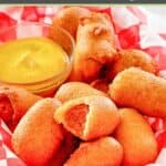 A bunch of homemade mini corn dogs in a serving basket.