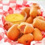 Homemade mini corn dogs piled in a serving basket.
