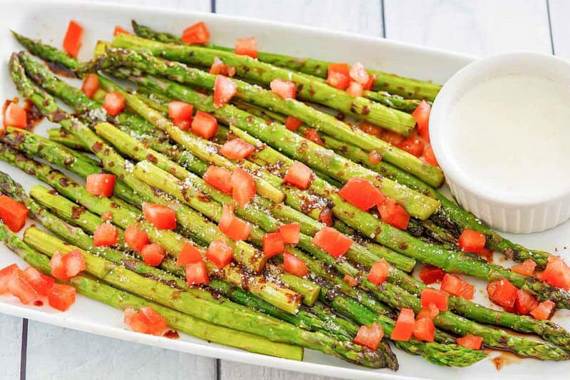 Copycat olive garden parmesan roasted asparagus on a rectangular plate.