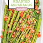 Homemade olive garden parmesan roasted asparagus and a cup of dipping sauce.