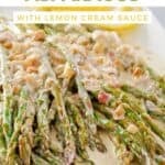 Sauteed asparagus with lemon cream sauce on a rectangular platter.