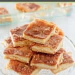 Homemade sopapilla cheesecake cut into bars and on a cake stand.
