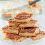 Homemade sopapilla cheesecake slices on a cake stand.