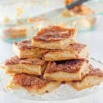 Homemade sopapilla cheesecake slices on a cake stand.