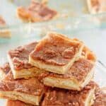 Homemade sopapilla cheesecake bars on a cake stand.