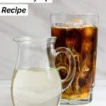 Homemade Starbucks classic syrup in a small pitcher in front of iced coffee.