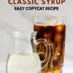 Homemade Starbucks classic syrup in a pitcher and an iced coffee next to it.