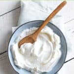 A small bowl of sweetened yogurt on top of a cloth napkin.