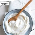 Sweetened yogurt and a wood spoon in a bowl.