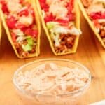 Homemade Taco Bell chipotle sauce in a small bowl and crunchy tacos behind it.