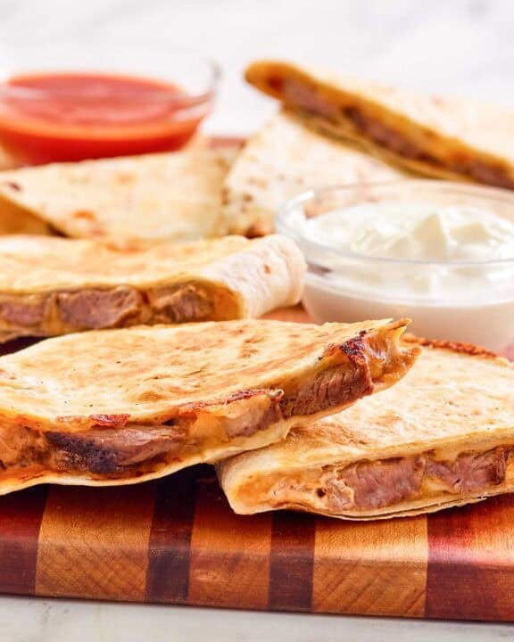 Copycat Taco Bell steak quesadilla on a wood serving board.
