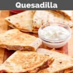 Homemade Taco Bell steak quesadilla and a small bowl of sour cream.