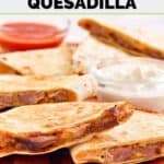Homemade Taco Bell steak quesadilla, sour cream, and taco sauce.