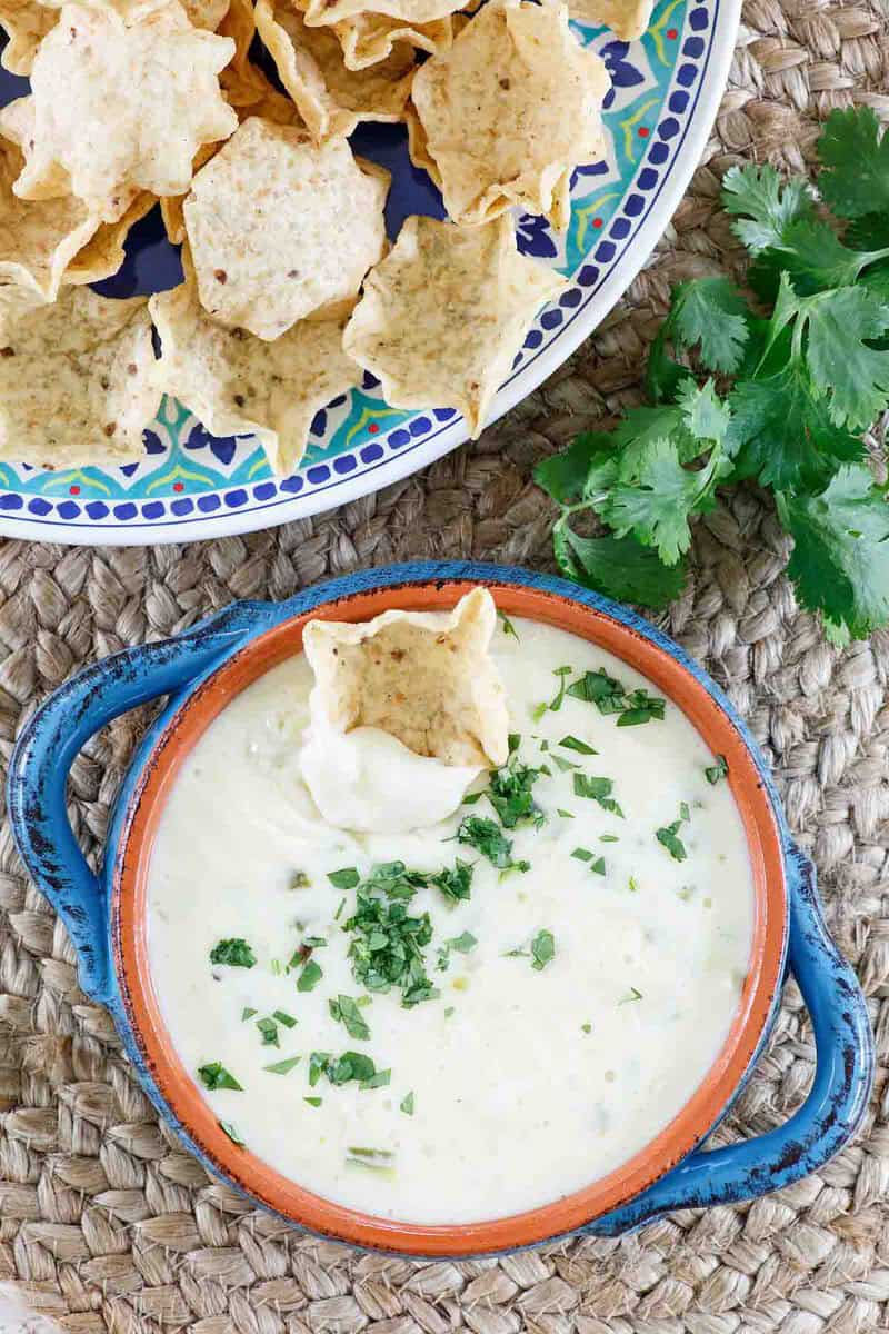 Homemade white queso dip served with tortilla chips.
