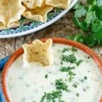A bowl of homemade Mexican white queso dip and tortilla chips.