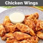 Homemade Wingstop Louisiana rub chicken wings and a small cup of ranch dressing.