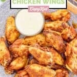 Homemade Wingstop Louisiana rub wings and a small cup of dipping sauce on a plate.