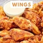 A plate of homemade Wingstop Louisiana rub chicken wings with dipping sauce.
