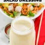 Homemade Applebee's oriental dressing in a mason jar and a salad behind it.