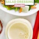 Homemade Applebee's oriental dressing in a a jar next to a salad.
