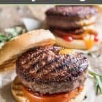Grilled backyard burgers with tomato, mustard, and ketchup.