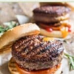 Two backyard grilled burgers with ketchup, mustard, and tomato.