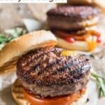 Two grilled backyard burgers with sesame seed buns.
