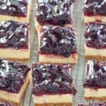 Blueberry cheesecake bars scattered on a wire rack.