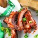 Homemade Chili's baby back ribs, parsley, and a kitchen towel.