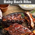 Homemade Claim Jumper ribs on a plate and a cup of bbq sauce.